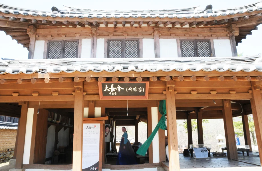 Wooden pavilion with a Dae Jang Geum signboard and costume display at MBC Dae Jang Geum Park