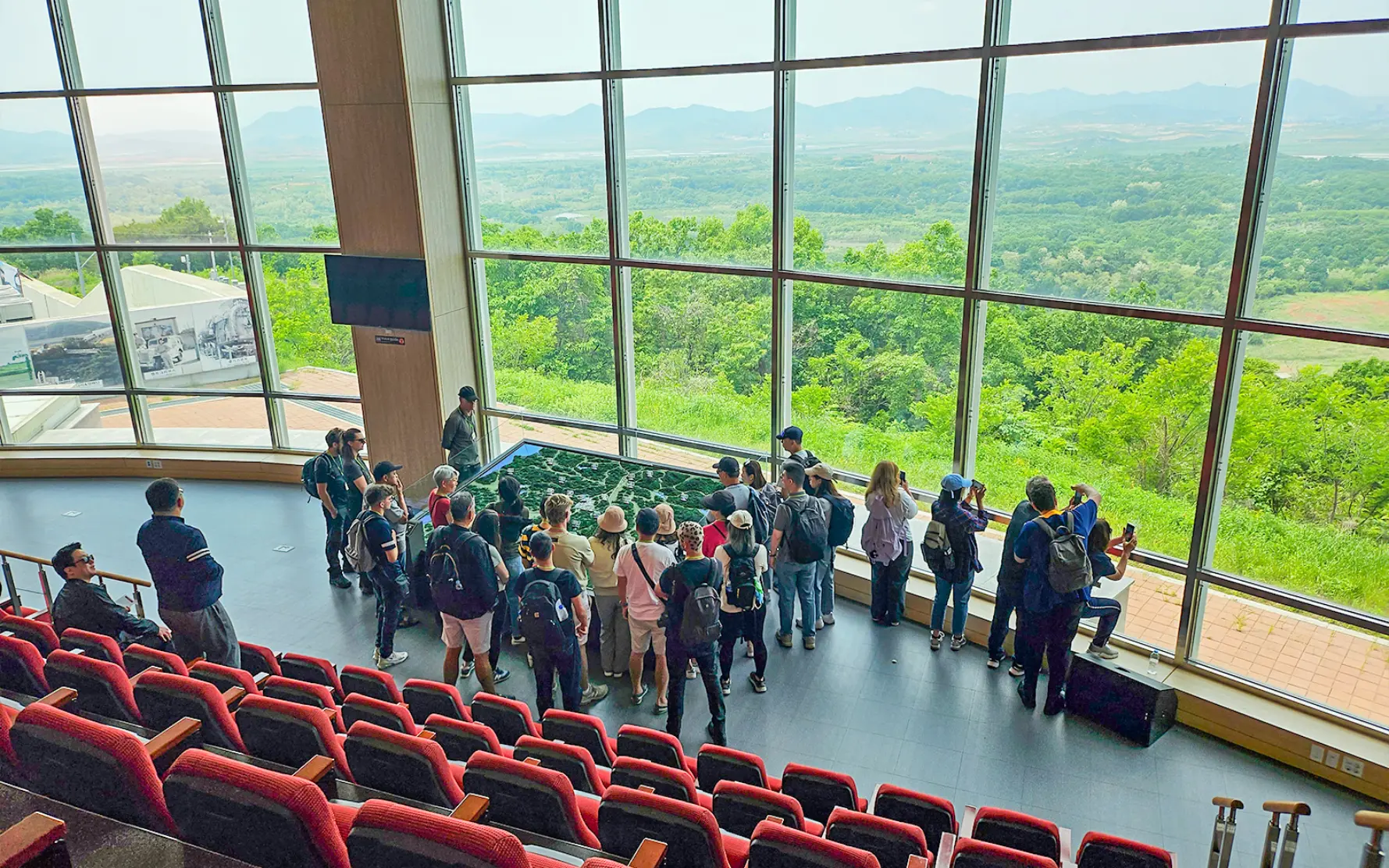 Visitors looking out over the DMZ from the glass-walled Dora Observatory hall