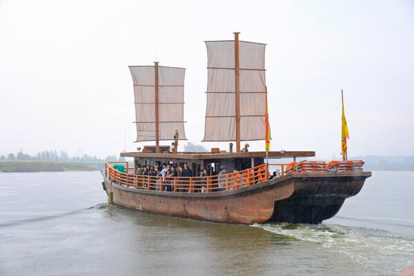 Wooden replica Baekje sailing ship carrying visitors on the Baengmagang River