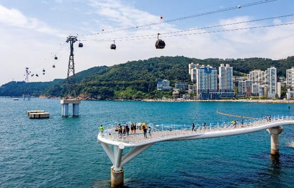Songdo Skywalk pier with the Busan Air Cruise cable cars crossing the bay