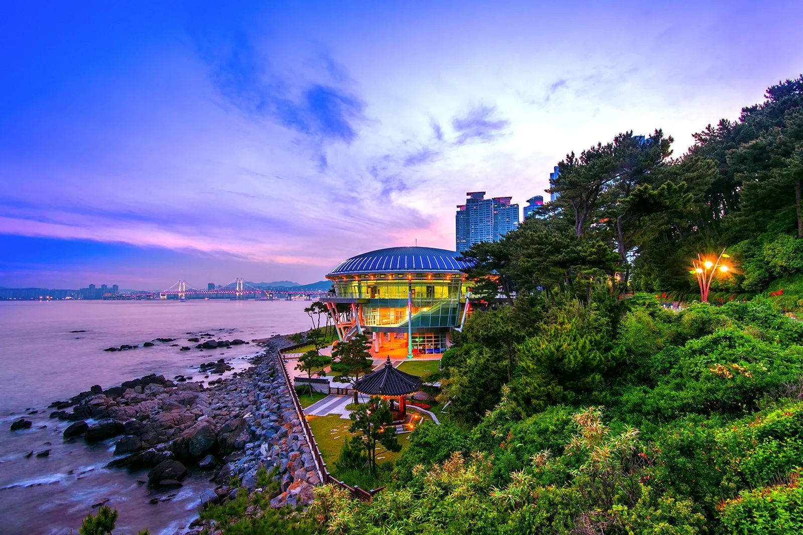 Nurimaru APEC House and Gwangandaegyo Bridge at sunset on the Busan coast