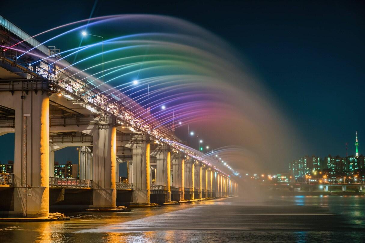 Banpo Bridge Rainbow Fountain casting colourful arcs over the Han River at night