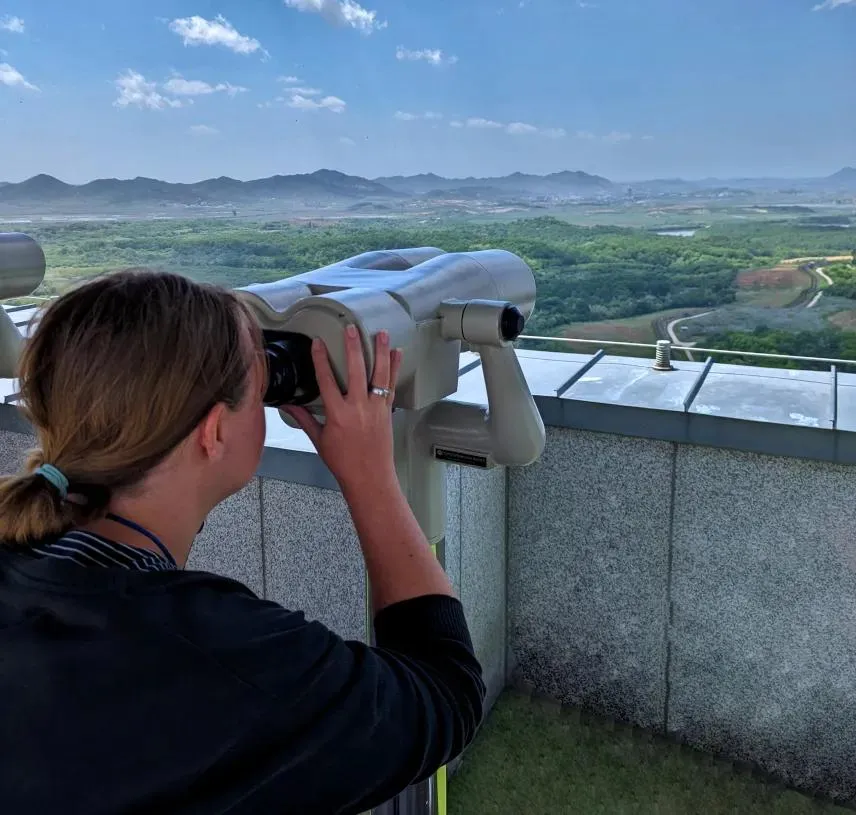 Visitor looking through binoculars toward the DMZ