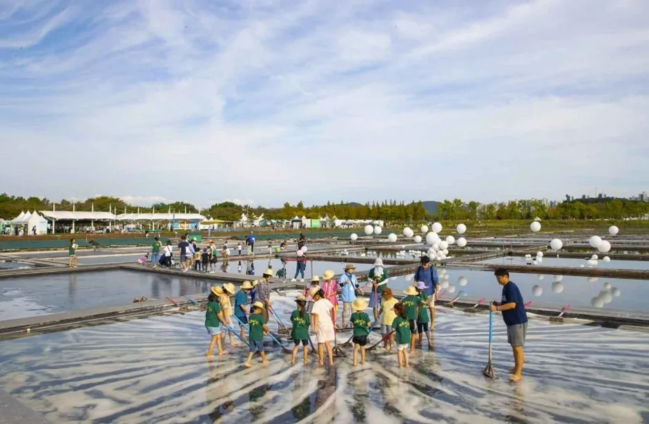 Children and families taking part in a traditional salt-field experience in Siheung