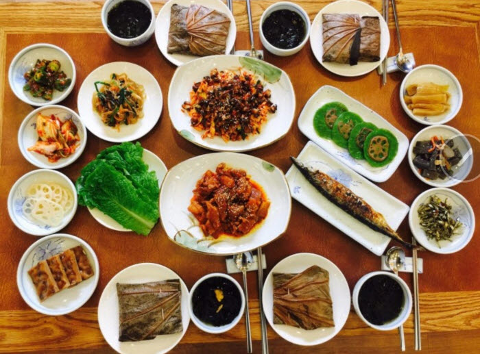 Korean lotus-leaf rice meal served with grilled fish, vegetables and assorted side dishes