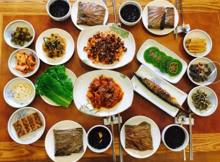 Korean lotus-leaf rice meal served with grilled fish, vegetables and assorted side dishes