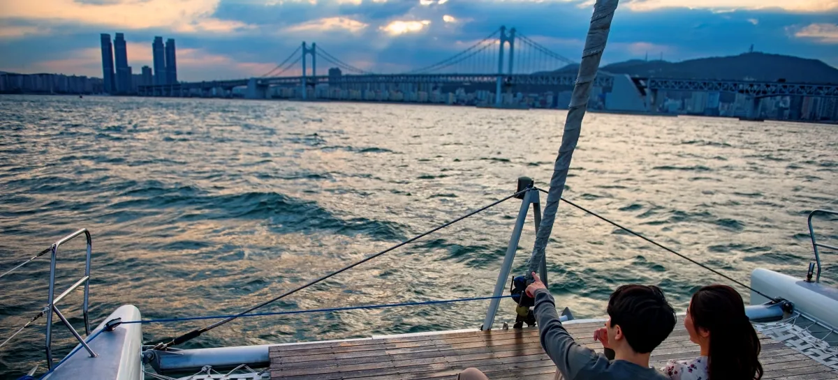 Sailing a catamaran past Gwangandaegyo Bridge on the Busan coast
