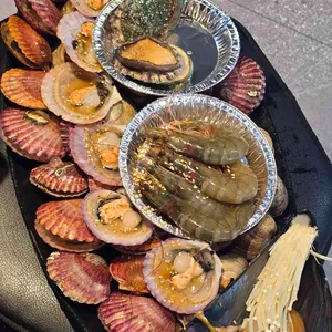 Scallops, prawns and abalone arranged on a west-coast seafood grill