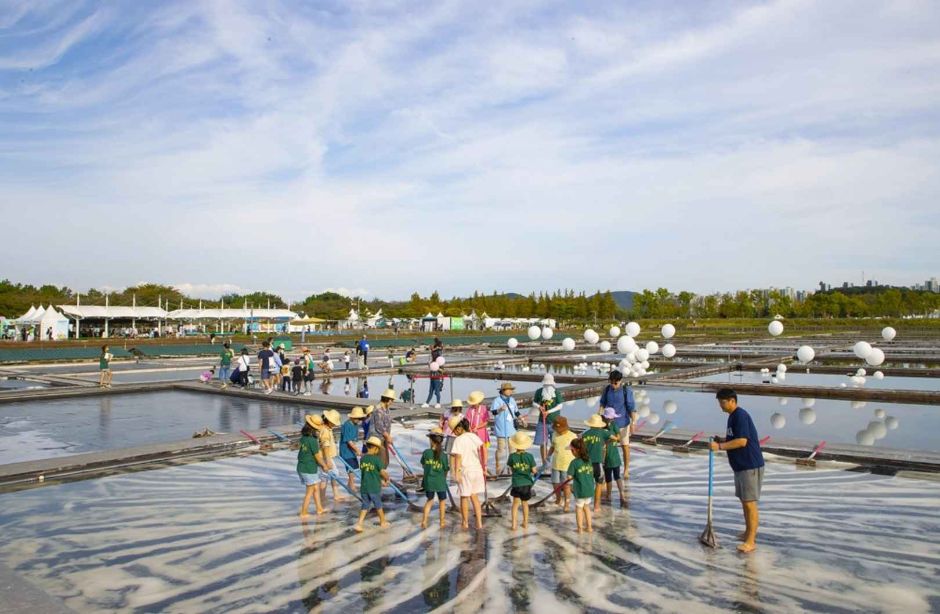 Children and families taking part in a traditional salt-field experience in Siheung