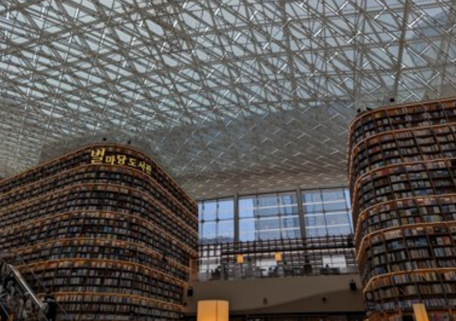 Towering curved bookshelves beneath the glass roof of Starfield Library at COEX in Gangnam