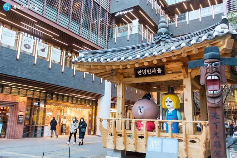 Insadong street entrance pavilion with character statues and craft shops