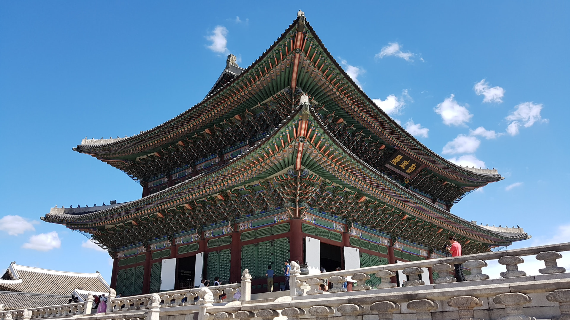 Geunjeongjeon throne hall of Gyeongbokgung Palace with its double-tiered roof against a blue sky