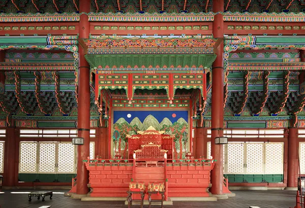 Ornate royal throne and painted wooden interior inside Geunjeongjeon Hall at Gyeongbokgung Palace