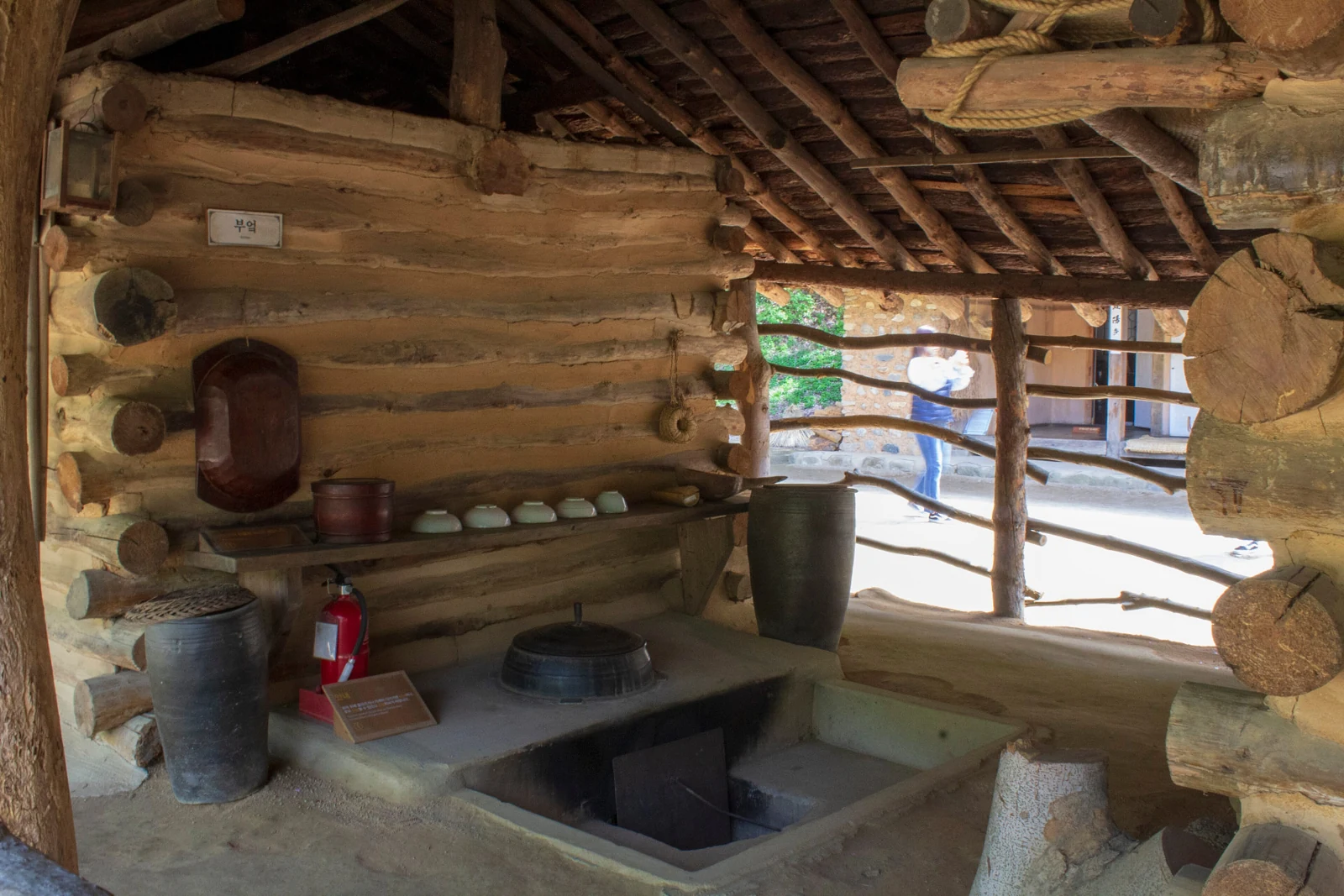 Traditional kitchen with earthen walls, pottery and a built-in hearth