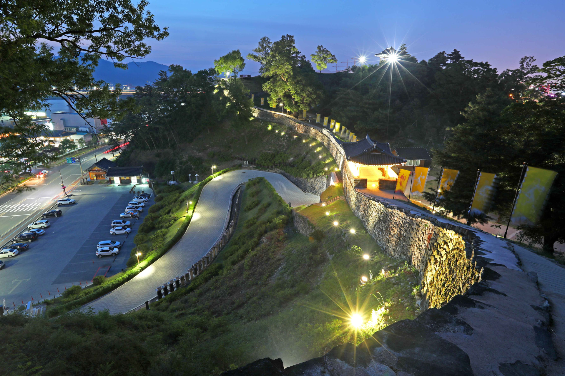 Gongsanseong fortress walls and a traditional Baekje pavilion illuminated at twilight in Gongju