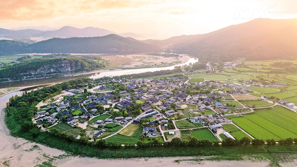 Aerial view of Andong Hahoe Village beside the winding Nakdong River at sunset