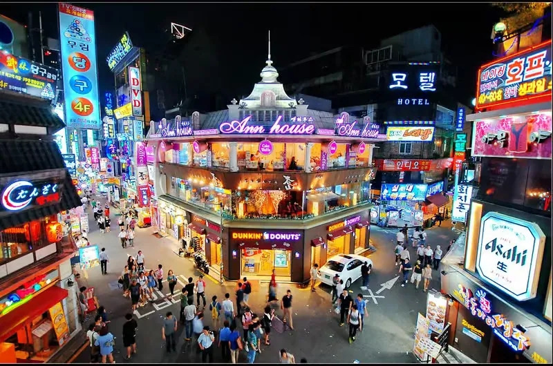 Colourful pedestrian shopping street lined with fashion stores in Hongdae, Seoul