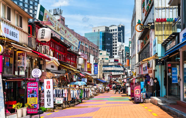 Colourful pedestrian shopping street lined with fashion stores in Hongdae, Seoul